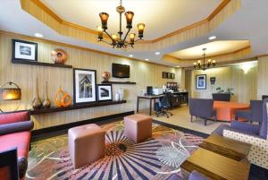 a lobby of a hotel with chairs and a table at Hampton Inn Sturgis in Sturgis