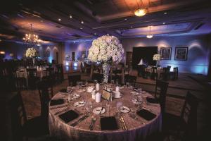a dining room with a table with a vase of flowers at DoubleTree by Hilton Sunrise - Sawgrass Mills in Sunrise +35 photos