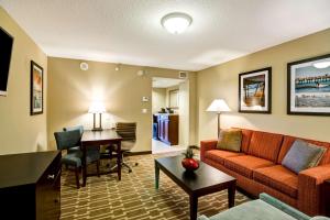 a living room with a couch and a table at Embassy Suites Fort Myers - Estero in Estero