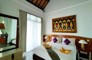 a bedroom with a large bed and a large window at The Trawangan Resort in Gili Trawangan +168 photos