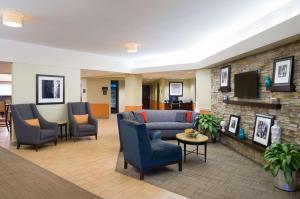 a lobby with a couch and chairs and a tv at Hampton Inn Carlisle in Carlisle