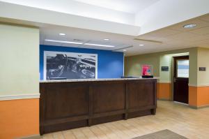 an office lobby with a desk with a car on the wall at Hampton Inn Carlisle in Carlisle