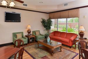 a living room with a red couch and chairs at Hampton Inn Houston-Deer Park Ship Area in Deer Park