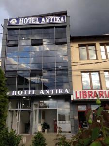 a building with a sign on the front of it at Hotel Antika in Prizren