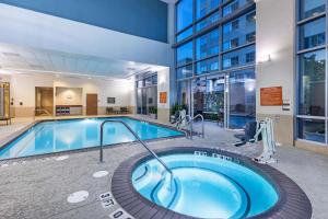 a large swimming pool in a building at Embassy Suites by Hilton Houston-Energy Corridor in Houston