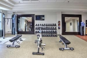 a gym with several treadmills and exercise machines at Embassy Suites by Hilton Indianapolis North in Indianapolis