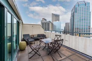 a balcony with chairs and a table on a building at Embassy Suites by Hilton Indianapolis Downtown in Indianapolis