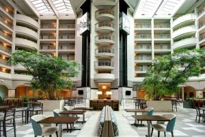 an empty cafeteria with tables and chairs in a building at Embassy Suites by Hilton Jacksonville Baymeadows in Jacksonville