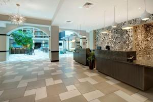a lobby of a hotel with a reception counter at Embassy Suites by Hilton Jacksonville Baymeadows in Jacksonville