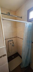 a shower with a plastic curtain in a bathroom at La casa de Boris 1 in Ushuaia