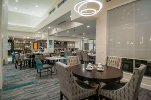 a dining room with tables and chairs in a restaurant at Hilton Garden Inn Jackson/Clinton in Clinton