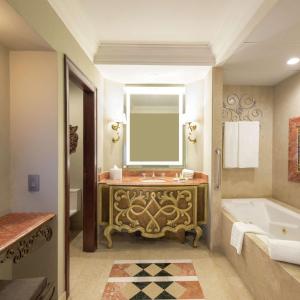 a bathroom with a tub and a sink with a mirror at Hilton Guatemala City, Guatemala in Guatemala