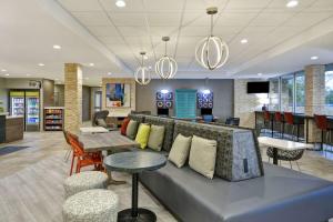 a living room with a couch and a table at Home2 Suites Houston Westchase in Houston