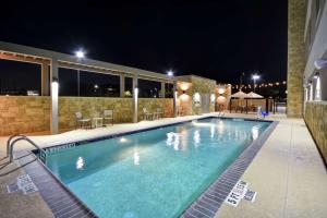 a swimming pool at night in a hotel at Home2 Suites Houston Westchase in Houston