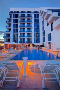 uma piscina de hotel com cadeiras e um edifício em Hotel Maren Fort Lauderdale Beach, Curio Collection By Hilton em Fort Lauderdale