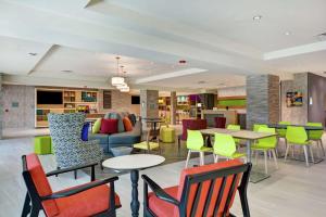 a restaurant with colorful chairs and tables in a lobby at Home2 Suites By Hilton Jacksonville South St Johns Town Ctr in Jacksonville