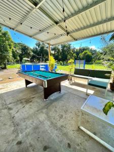 a pool table sitting under a pavilion at Casa Tela in Tela