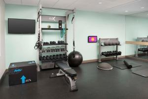 a room with a gym with weights and a tv at Tru by Hilton Beaufort, Sc in Beaufort