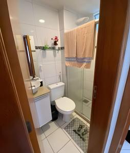 a small bathroom with a toilet and a shower at Ap 2/4 Prox ao shopping in Feira de Santana