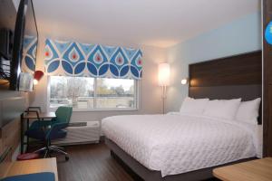 a hotel room with a bed and a window at Tru By Hilton Chambersburg in Chambersburg