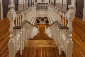 a staircase with white railings and wood floors at Hotel Florence, Tapestry Collection by Hilton in Florence