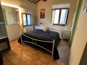 a bedroom with a bed in a room with windows at Locanda del Tavolo Matto in Potenza Picena