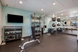a fitness room with a gym with a flat screen tv at Tru By Hilton Warsaw, In in Warsaw