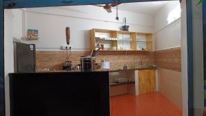 a kitchen with a counter in a room at Abhi's cafe avaduthura kovalam in Kovalam