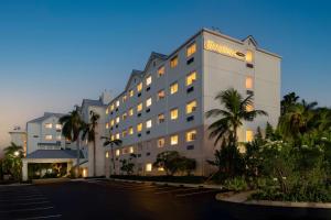 a hotel with a sign on the side of it at Hampton by Hilton Grand Cayman Seven Mile Beach in George Town