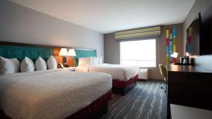 a hotel room with two beds and a television at Hampton Inn & Suites St Clairsville, Oh in Saint Clairsville