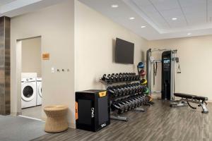 a room with a gym with a washing machine at Home2 Suites by Hilton Fort Myers Airport in Fort Myers