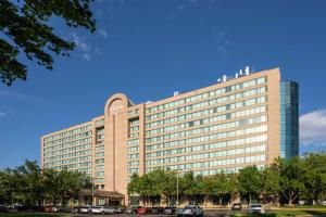 a large building with cars parked in front of it at Hilton Fairfax, Va in Fairfax