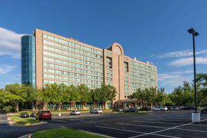 a large building with a parking lot in front of it at Hilton Fairfax, Va in Fairfax