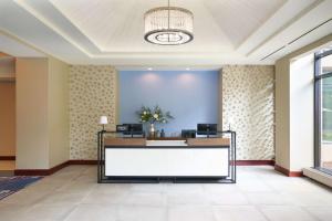 a lobby of a hotel with a reception desk at Hilton Fairfax, Va in Fairfax