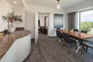 a kitchen and dining room with a table and chairs at Hilton Fairfax, Va in Fairfax
