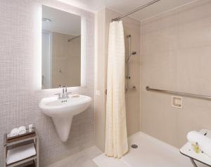 a bathroom with a sink and a shower at Hilton Fairfax, Va in Fairfax