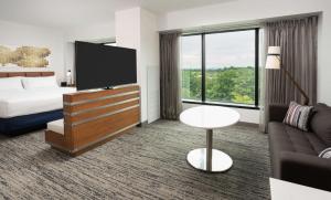 a hotel room with a bed and a television at Hilton Fairfax, Va in Fairfax