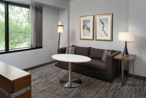 a living room with a couch and a table at Hilton Fairfax, Va in Fairfax