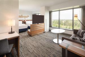 a hotel room with a bed and a tv at Hilton Fairfax, Va in Fairfax