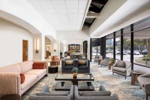 a lobby with couches and tables and windows at DoubleTree by Hilton Houston Medical Center Hotel & Suites in Houston