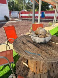 - un bol de rochers assis au-dessus d'une table en bois dans l'établissement Iglú Simbad con vista al cielo, à Barra de Navidad