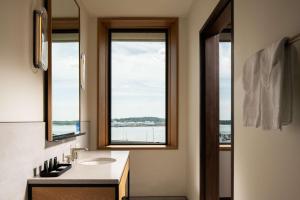 een badkamer met een wastafel en een raam bij Hotel Marcel New Haven, Tapestry Collection By Hilton in New Haven