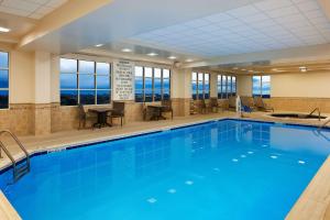 a large swimming pool with blue water in a building at Doubletree By Hilton Front Royal Blue Ridge Shadows in Front Royal