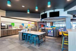 a mcdonalds restaurant with blue chairs and a counter at Tru By Hilton Port St Lucie Tradition in Port Saint Lucie