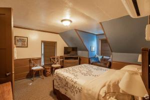 a hotel room with a bed and a television at Idyllwild Inn in Idyllwild