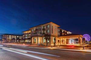 a building on the side of a street at night at Embassy Suites By Hilton Panama City Beach Resort in Panama City Beach