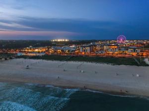 a view of a beach at night with a ferris wheel at Embassy Suites By Hilton Panama City Beach Resort in Panama City Beach