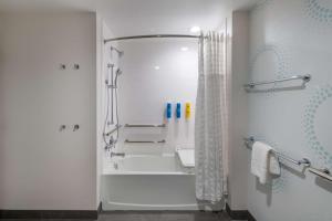 a white bathroom with a shower and a bath tub at Tru By Hilton Fayetteville Fort Bragg in Fayetteville +23 photos