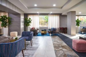 a lobby with chairs and tables and a living room at The Chifley Houston, Tapestry Collection by Hilton in Houston