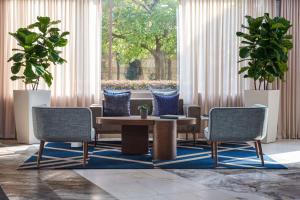 a lobby with two chairs and a table and a couch at The Chifley Houston, Tapestry Collection by Hilton in Houston